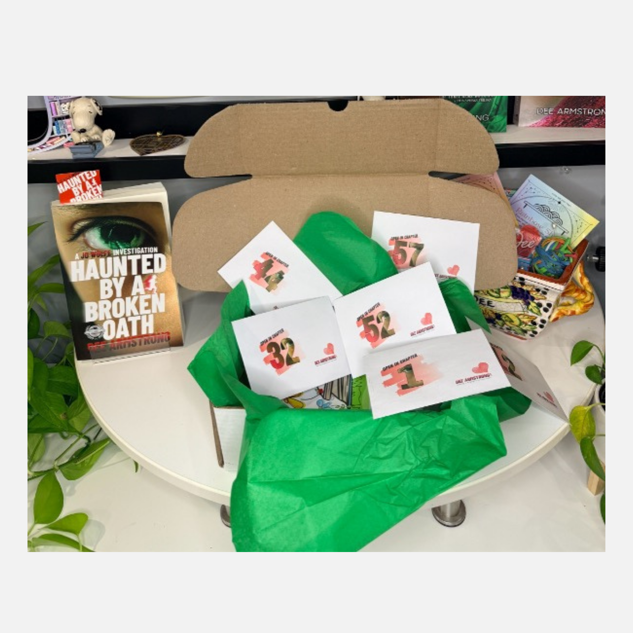 Open cardboard box with green tissue paper and trading cards on a white surface.
