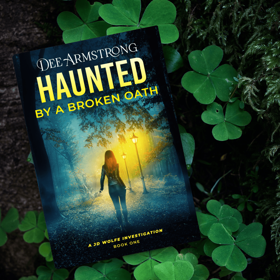 Book titled 'Haunted by a Broken Oath' by Dee Armstrong on clover leaves