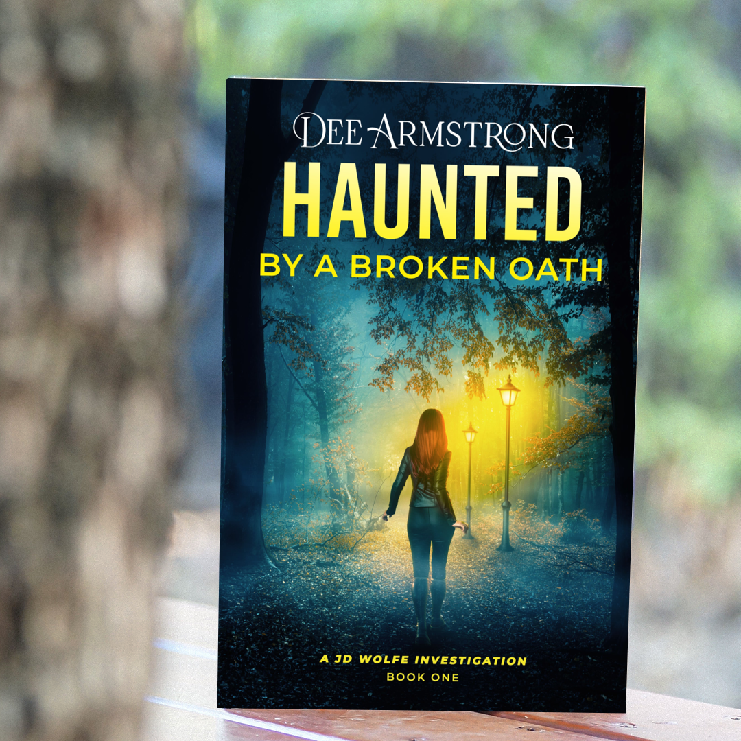 Book titled 'Haunted by a Broken Oath' by Dee Armstrong with a blurred background