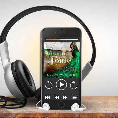 Phone displaying 'Visions of Emerald' on a stand with headphones nearby