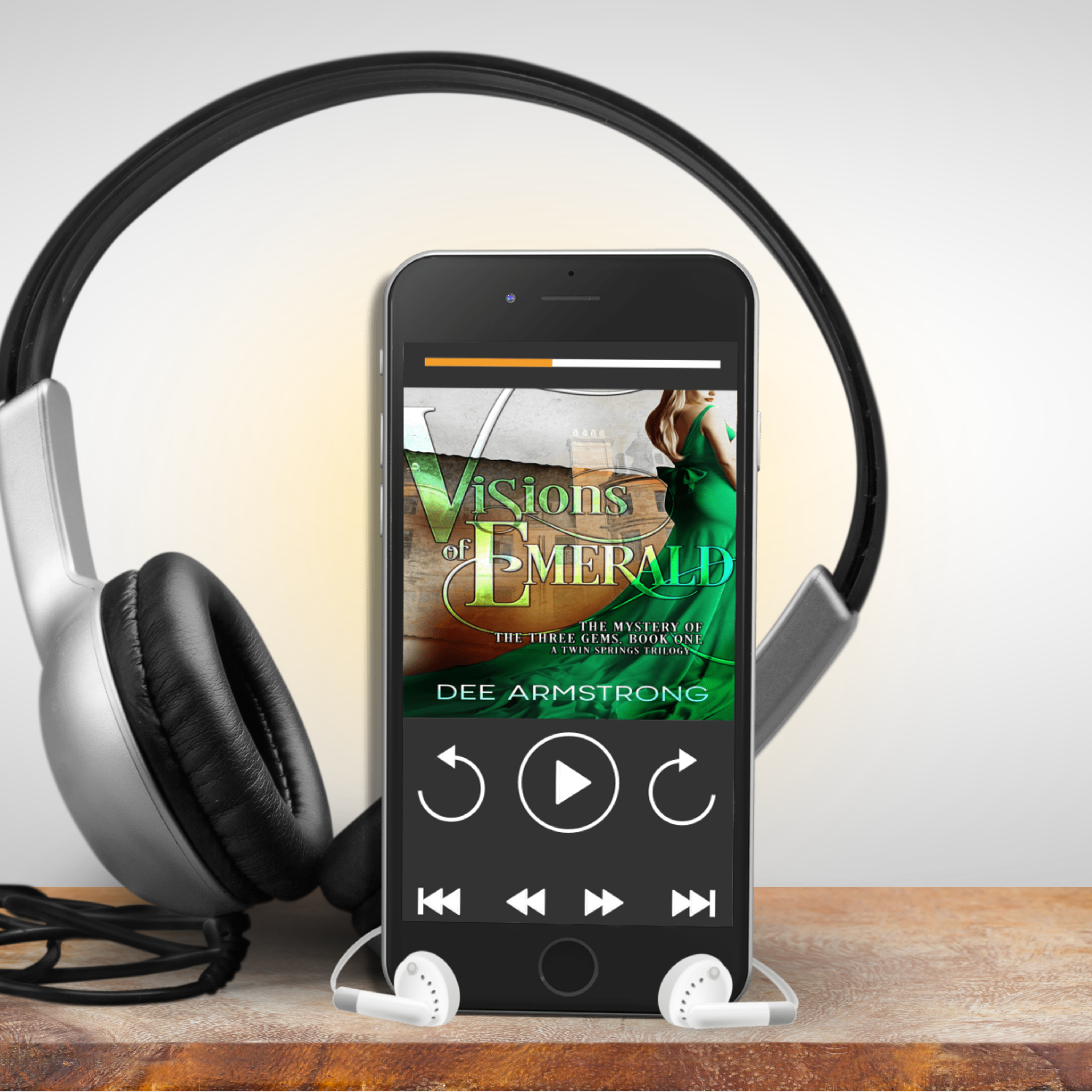 Phone displaying 'Visions of Emerald' on a stand with headphones nearby