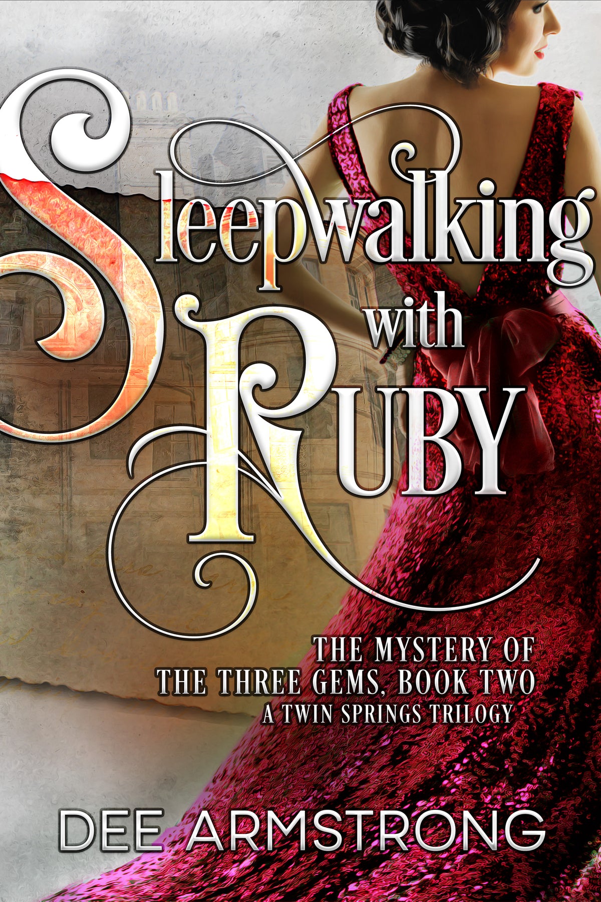 Book cover for 'Sleepwalking with Ruby' by Dee Armstrong featuring the title in stylized text and an image of a woman in a red dress, the story revolves around ghosts, mystery, and romance, set in the backdrop of the Twin Springs trilogy.